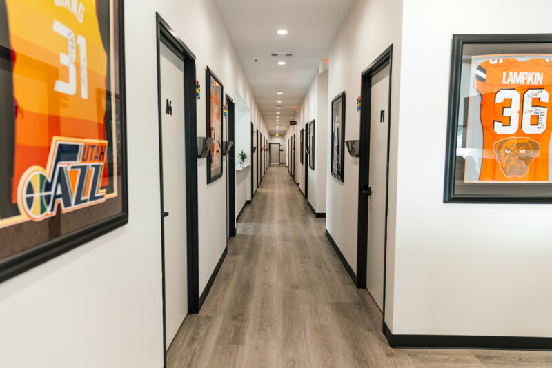 Clinic hallway lined with framed, signed sports jerseys